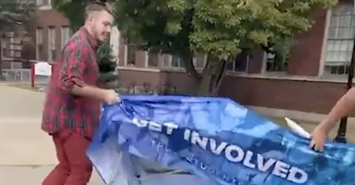 Photo allegedly showing Lopez flipping over a Turning Point USA table at Illinois State University earlier this month (YouTube/Times of India). 